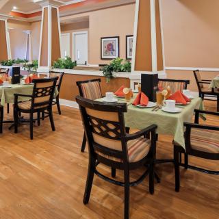 A well-decorated dining area with neatly set tables and chairs, ready for guests.