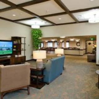 A modern lobby area with comfortable seating and a television.