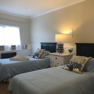 A cozy bedroom with twin beds and a calming decor.