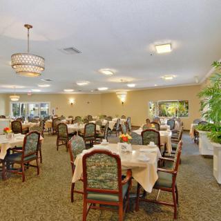 An elegant dining room with tables and chairs set up for service.