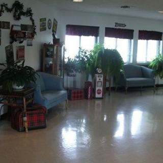 A cozy lobby with plants and seating.