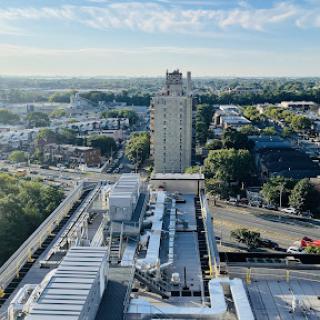 A panoramic view of a city showcasing modern buildings and infrastructure under a clear blue sky.