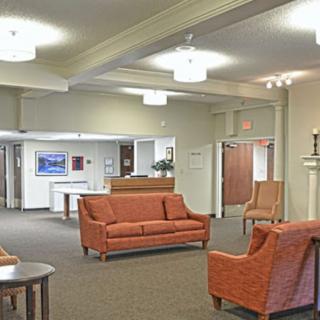 A well-lit lobby with comfortable seating and a reception desk.