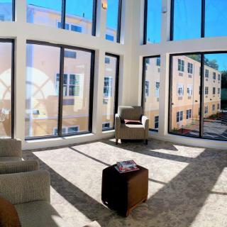A modern living room with large windows allowing abundant natural light.