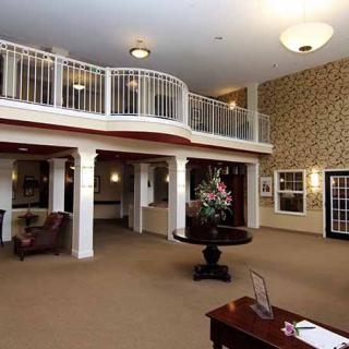 Spacious lobby with elegant decor and balcony view.