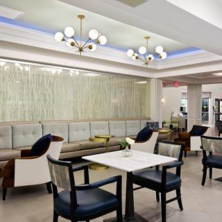 A modern lounge area with stylish seating and elegant chandeliers.