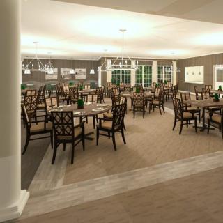 A spacious and elegantly designed dining room with multiple tables and chairs, well-lit for an inviting atmosphere.