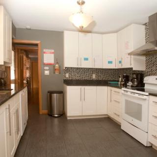 A modern kitchen featuring white cabinetry, a sleek countertop, and contemporary appliances.