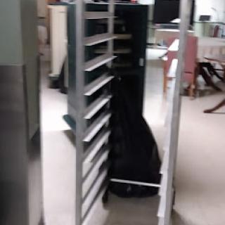 A multi-tiered shelf for storage in an office setting.