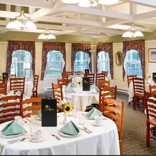 An elegant dining room with neatly arranged tables and chairs, ready for guests.