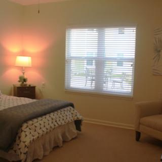 A cozy bedroom with a soft color palette and ample natural light.