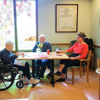 Seniors enjoying a moment together in a care facility.