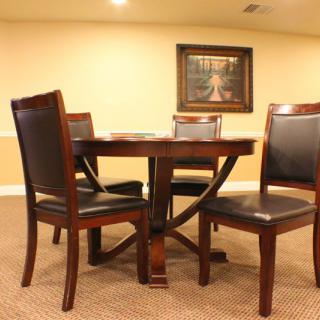 A cozy dining area with a wooden table and four chairs.