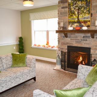 A cozy living room featuring a stone fireplace and inviting decor.