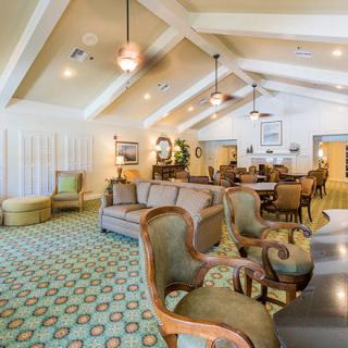 A spacious and elegantly decorated living room with comfortable seating and stylish lighting.