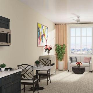 A modern living room with a kitchenette, stylish furniture, and vibrant artwork.