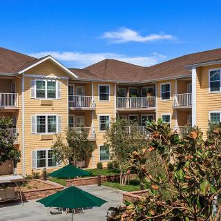 A modern apartment building with a landscaped courtyard.