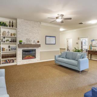 Spacious living room with a cozy fireplace and modern decor.