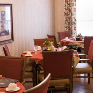 A cozy dining room with tables set for a meal.