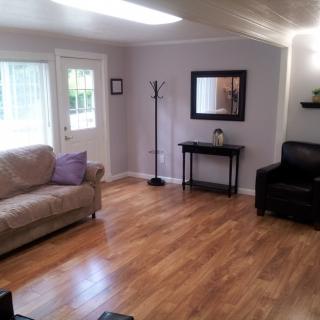 A cozy living room with comfortable seating and wooden flooring.