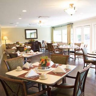 A cozy dining area with elegantly set tables and comfortable seating.