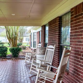 A cozy porch with rocking chairs inviting relaxation and comfort.