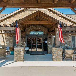 A stone building entrance adorned with American flags.