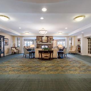A spacious and elegantly furnished lobby with cozy seating and warm lighting.