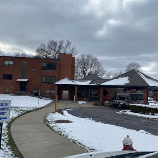 A view of a building covered in snow on a cloudy winter day.