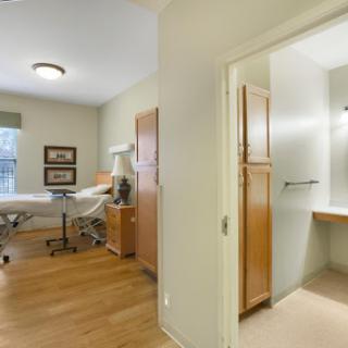 A well-lit medical treatment room featuring a consultation table and modern decor.