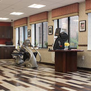 A well-equipped rehabilitation center featuring various exercise machines and a bright, inviting interior.