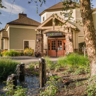 A charming restaurant exterior with lush greenery and a welcoming entrance.