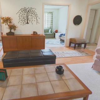 A modern living room with wooden furniture and minimalist decor.