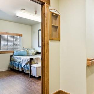 A cozy room with a single bed and a wooden floor.
