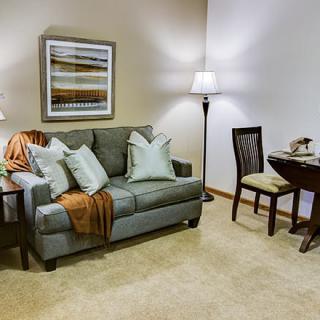 A cozy living room featuring a comfortable sofa, stylish lamps, and elegant decor.