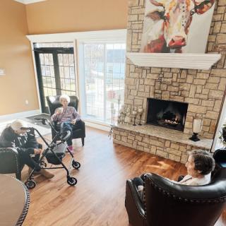 An interview setup in a cozy living room featuring a fireplace and large windows.