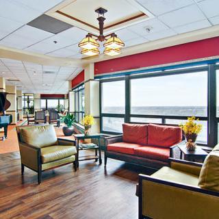 A spacious and well-lit lobby featuring comfortable seating arrangements with modern interior design.