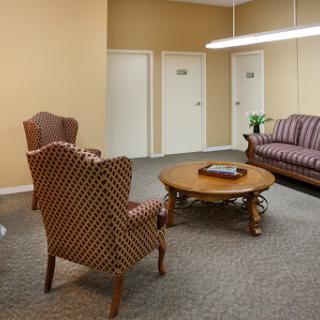 A cozy waiting area featuring comfortable seating and a warm color palette.