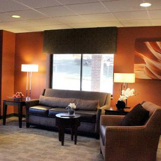 A cozy living room setup with modern furnishings and warm colors.