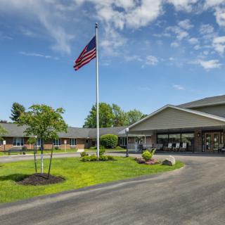 A building with an American flag on a clear sunny day.
