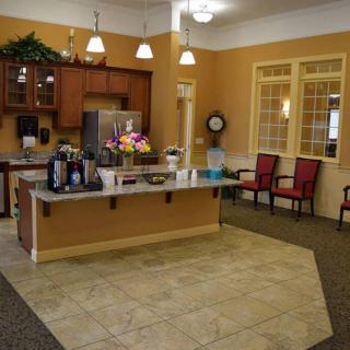 A cozy kitchen interior with a central counter and seating area.