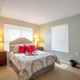 A cozy bedroom with a neatly made bed and warm lighting.