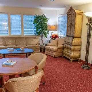 A cozy living room with assorted furniture and warm lighting.
