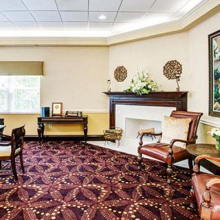 A well-decorated living room with elegant furniture and a patterned carpet.