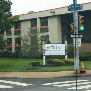A view of a building with a sign indicating 'York', set in an urban environment with traffic infrastructure.
