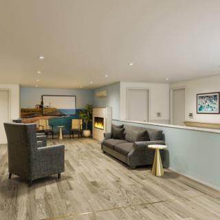 A modern living room with stylish furniture and wood flooring.