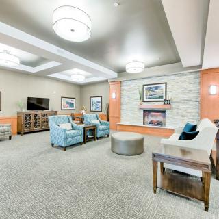 A modern living room with comfortable seating and a fireplace.