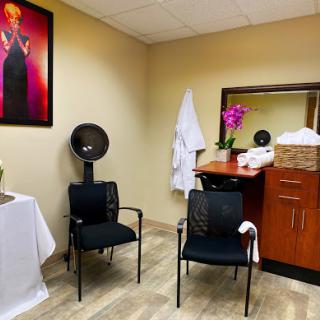 A serene waiting area in a spa, featuring comfortable chairs and calming decor.