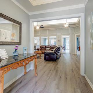 A stylish living area featuring elegant furniture and decor with hardwood flooring.