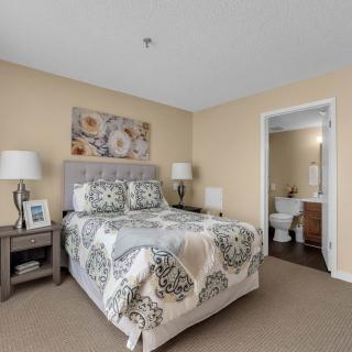 Cozy bedroom with floral decor and an ensuite bathroom.